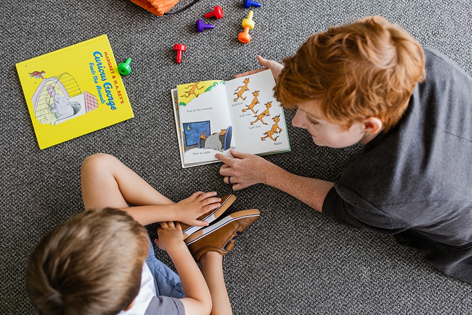 Woman and child playing and reading