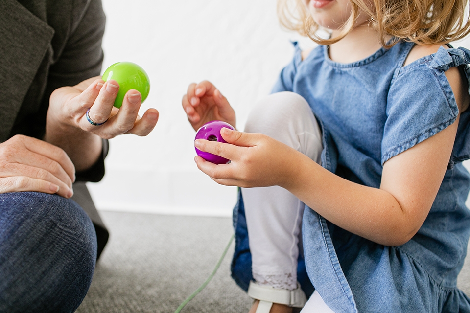 Woman and girl playing with toys